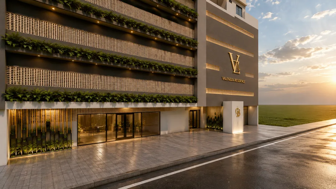 Base do Valenzza Residence vista da calçada ao entardecer, com o acesso principal envidraçado, brises vazados, jardineiras iluminadas e o monograma VZ em dourado
